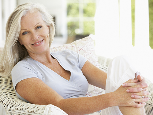 Older woman relaxing outside during the summer.>